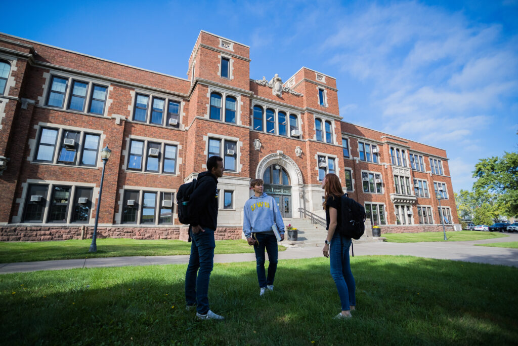 Students standing in front of the Old Main building