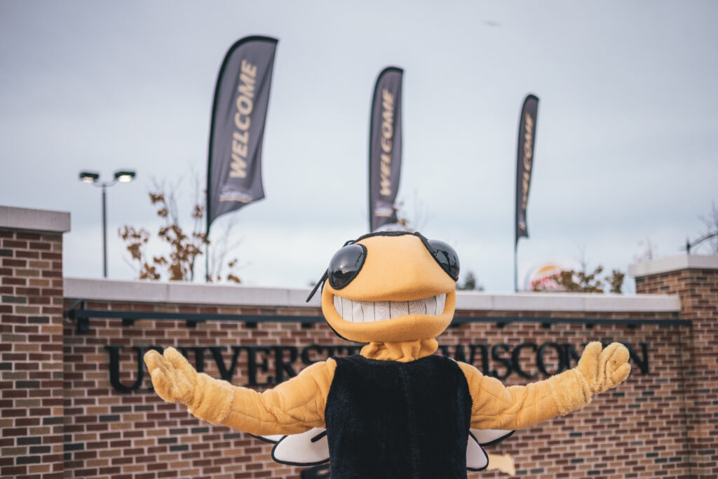 Buzz in front of University welcome banners