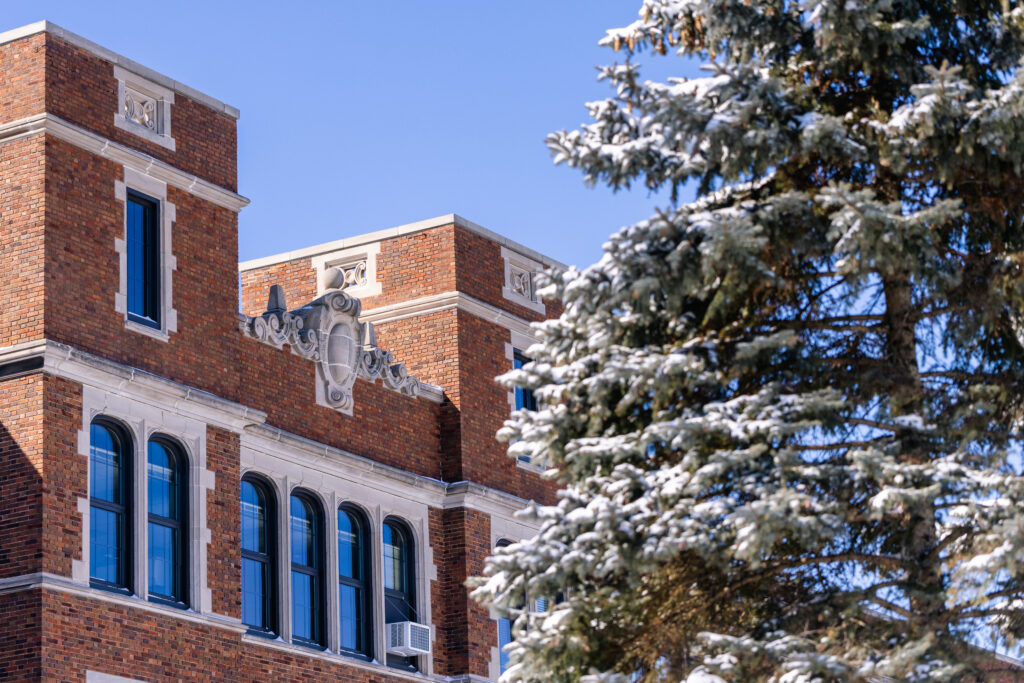 Old Main exterior and snow-covered tree