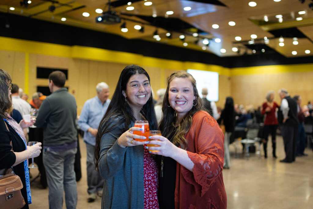 Two people holding glasses cheersing