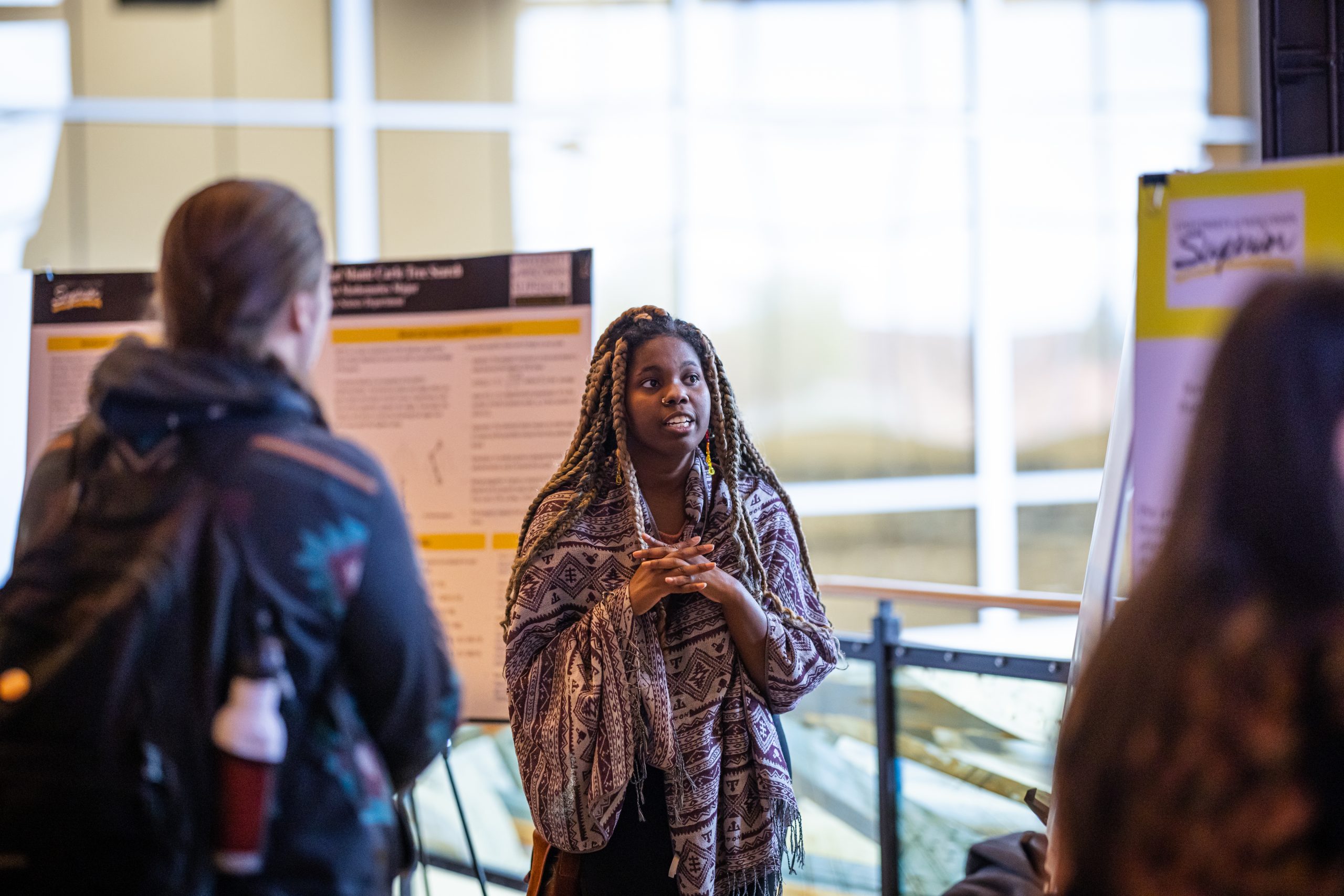 Student explaining research project