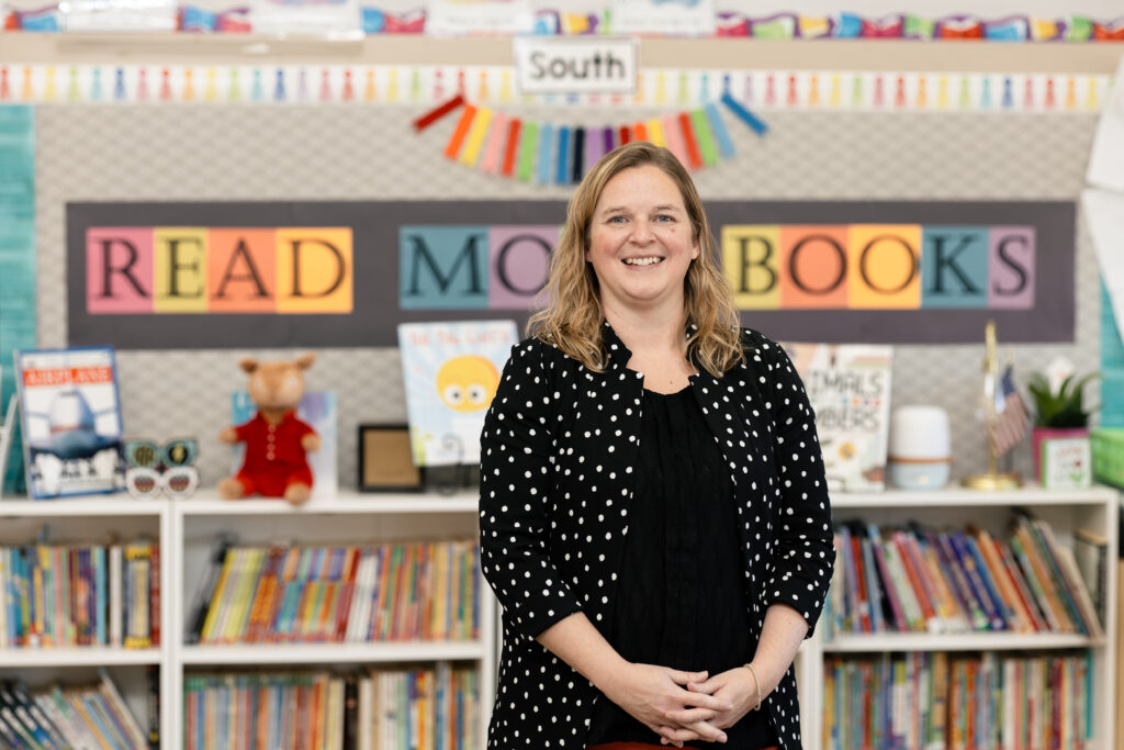 Woman standing in front of bookshelf