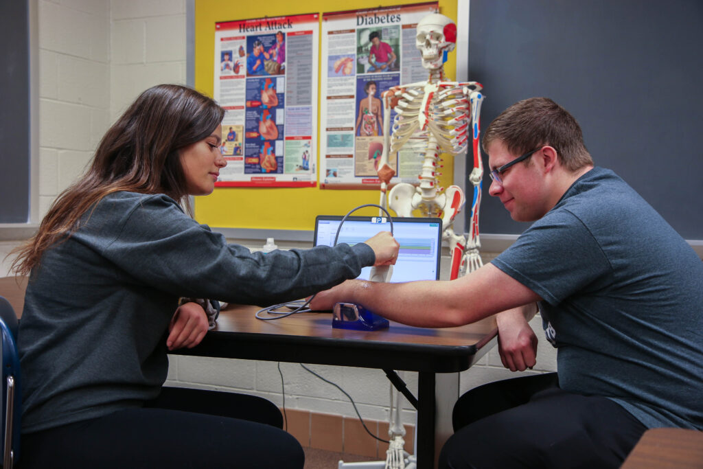 Two student engaged in a medical test