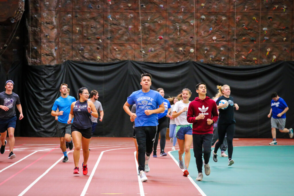 Students running on the indoor track