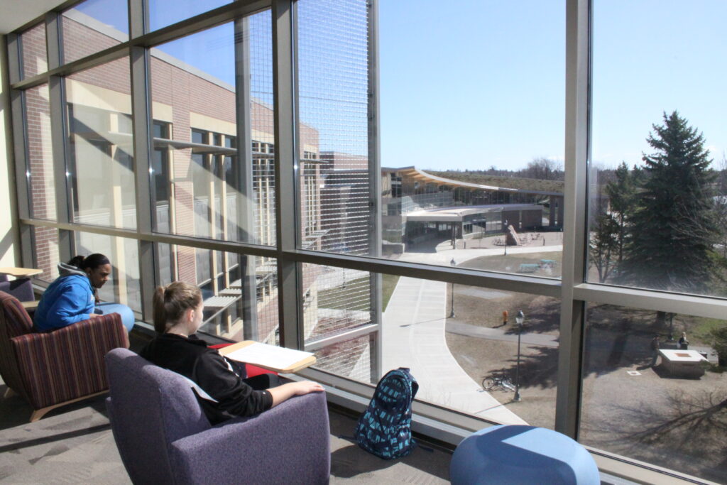 Students in sitting in Swenson Hall, overlooking the YU