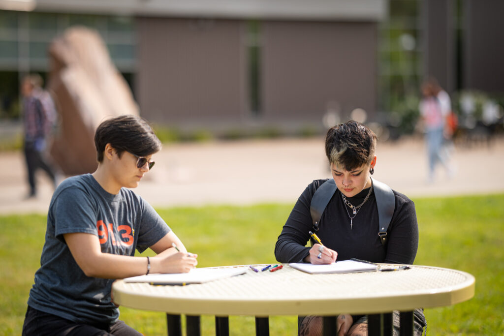 Two students studying outside