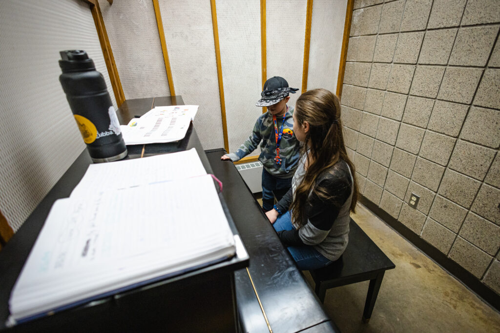 Two people practicing the piano