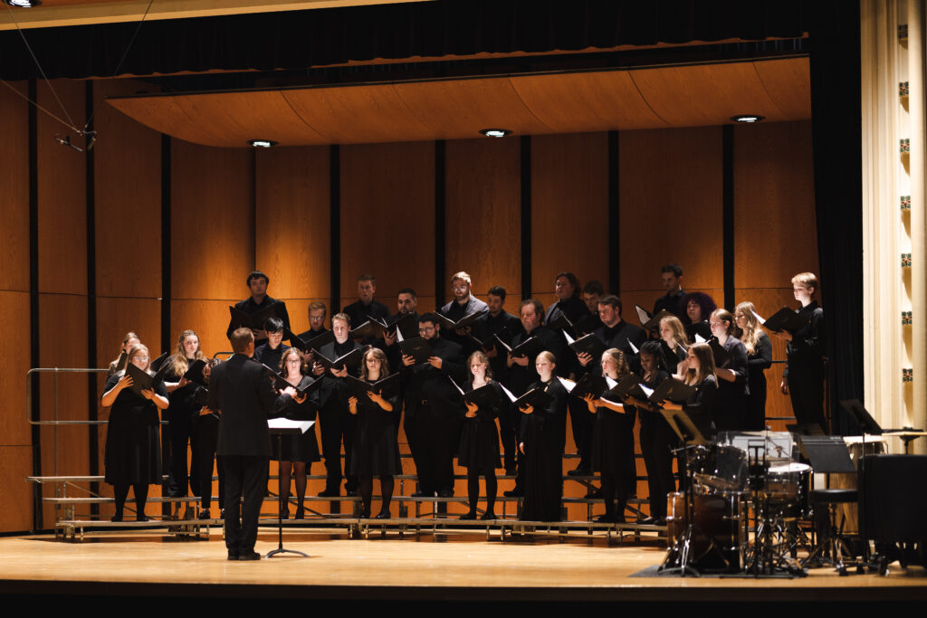 A student choir dressed in all black