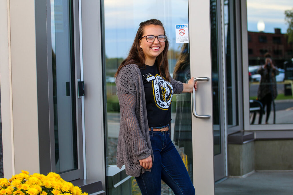 Student opening a door