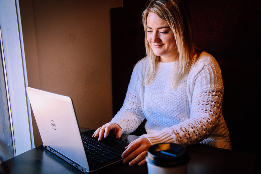 Woman smiling at laptop