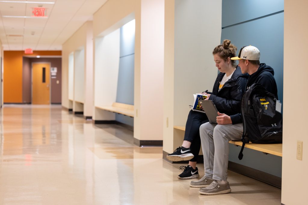 Students sitting in Swenson hallway