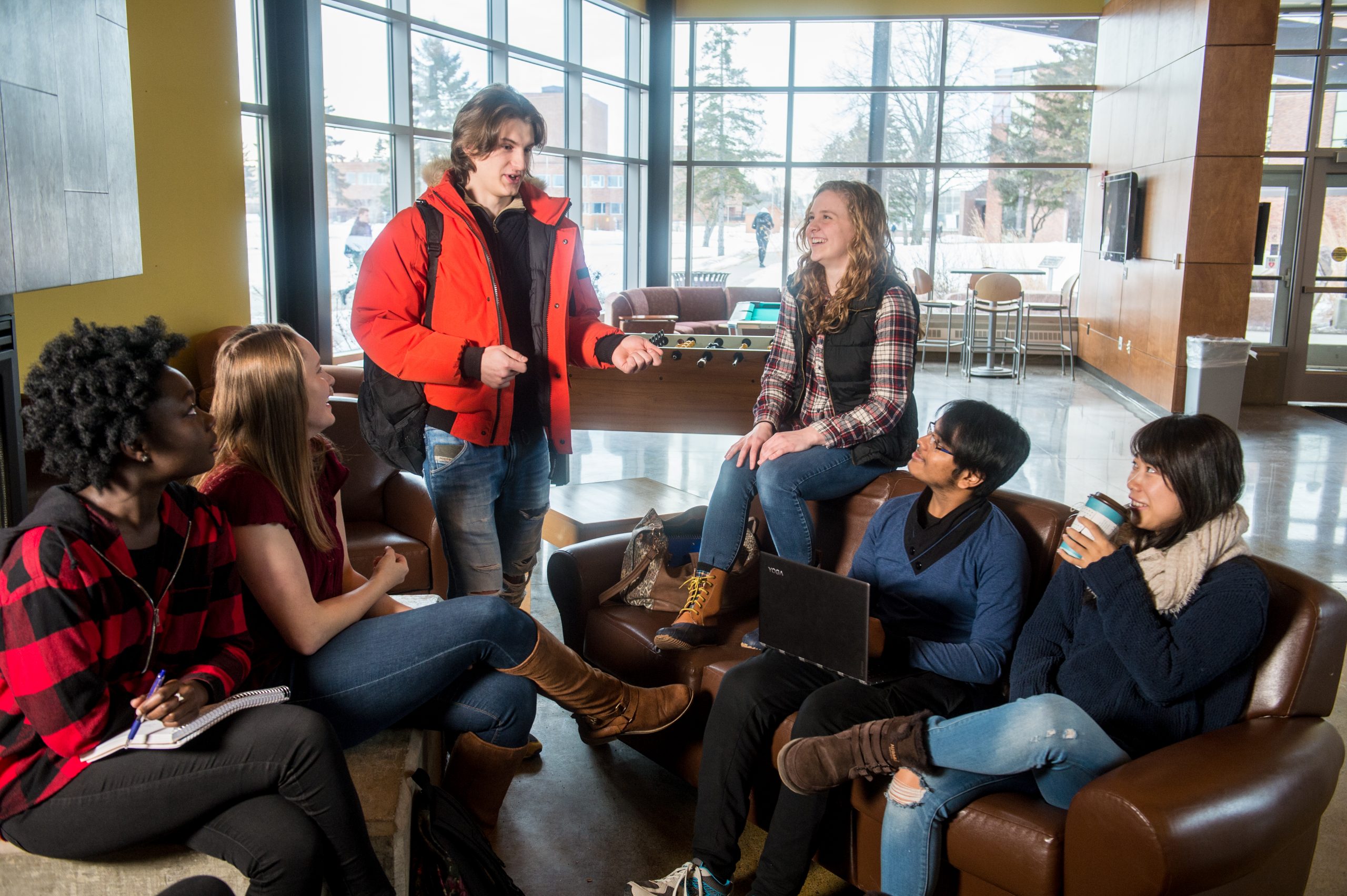 Students discussing by the couches in YU Atrium