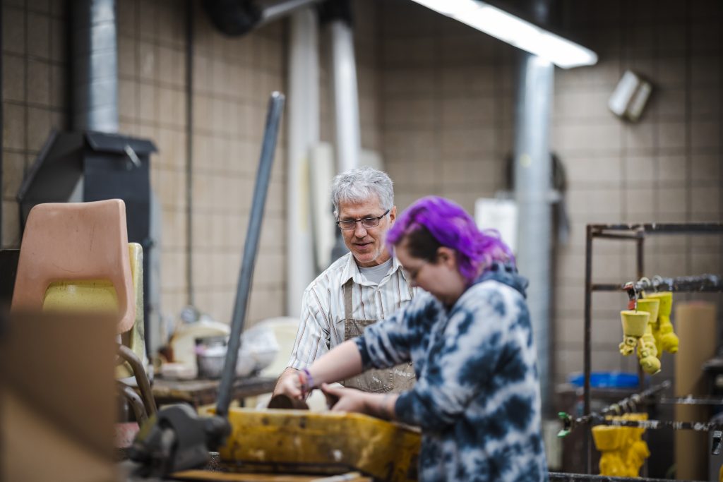 UW-Superior professor teaching a student in a sculpture class