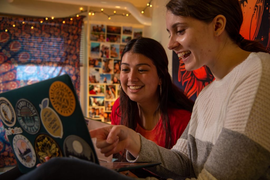 Two students hanging out in dorm