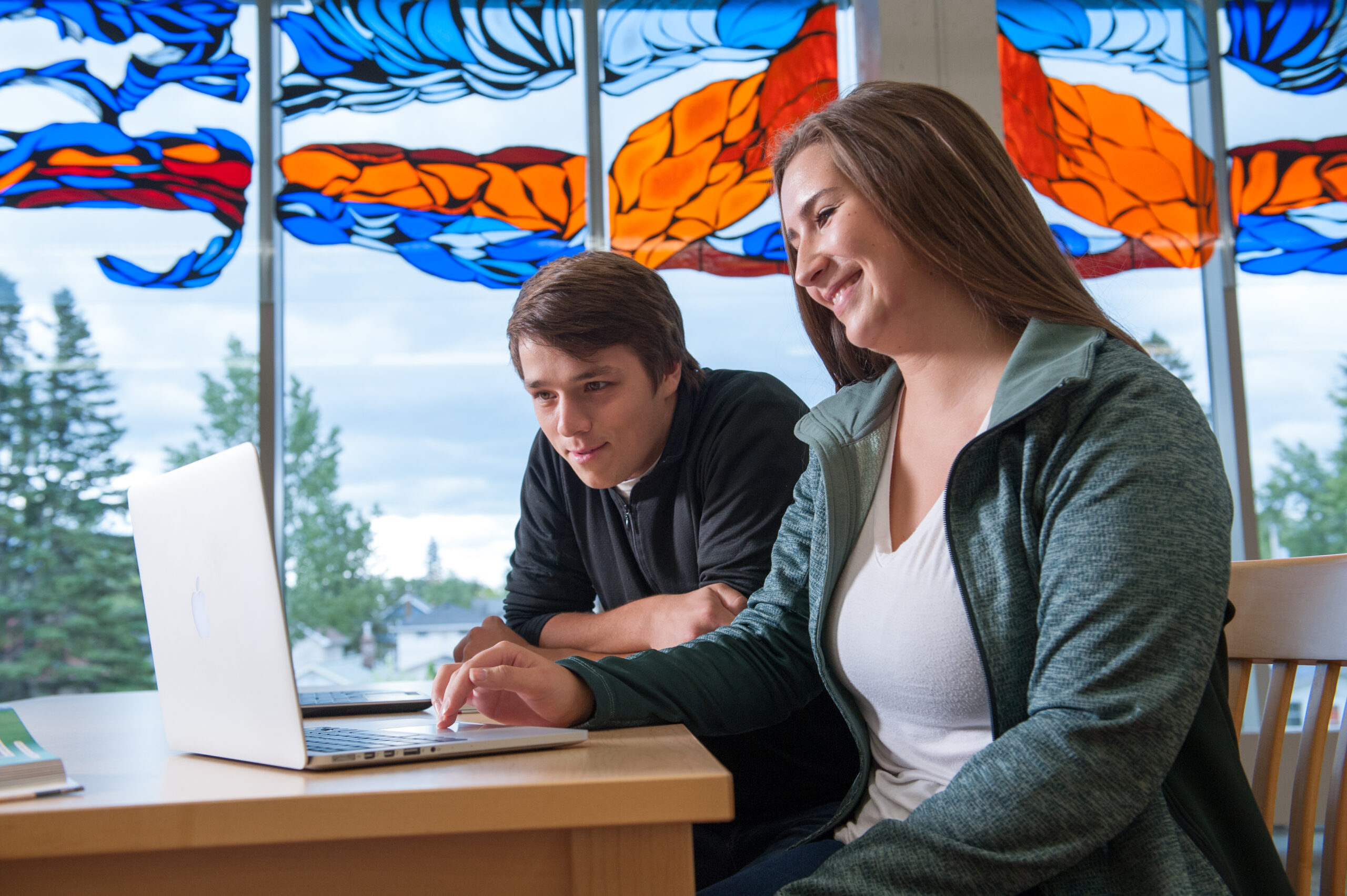 Students studying together with laptop