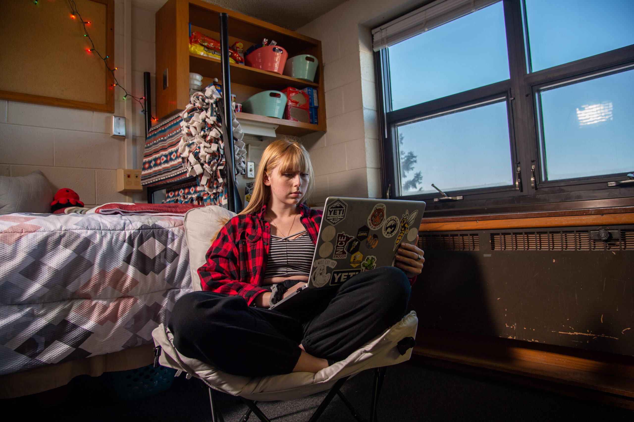 Student using laptop in dorm room